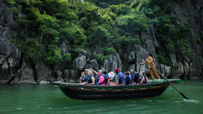 Small boat rowing on Lan Ha Bay