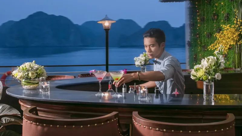 Sip on drink at outdoor bar