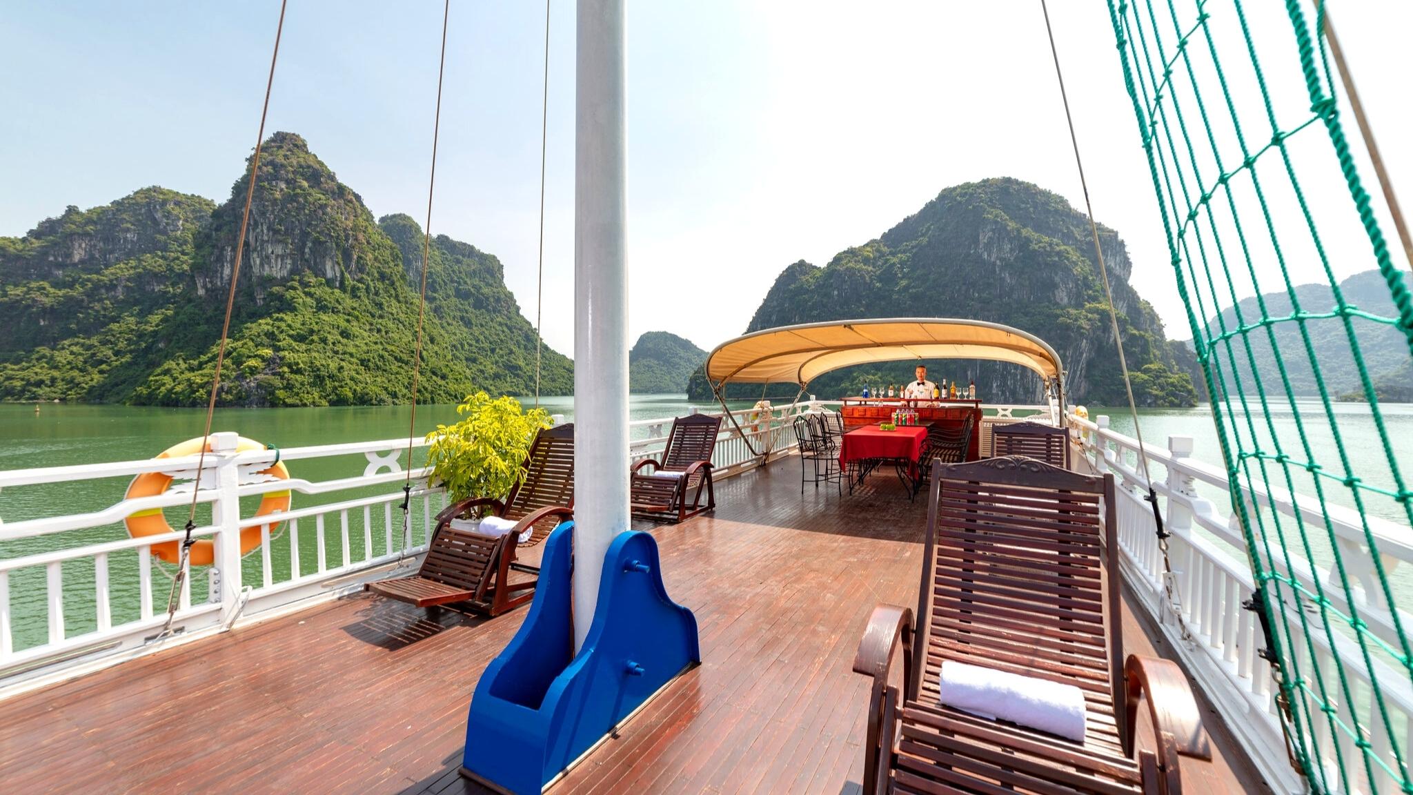 Spacious top deck with elegant sunbeds and small bar