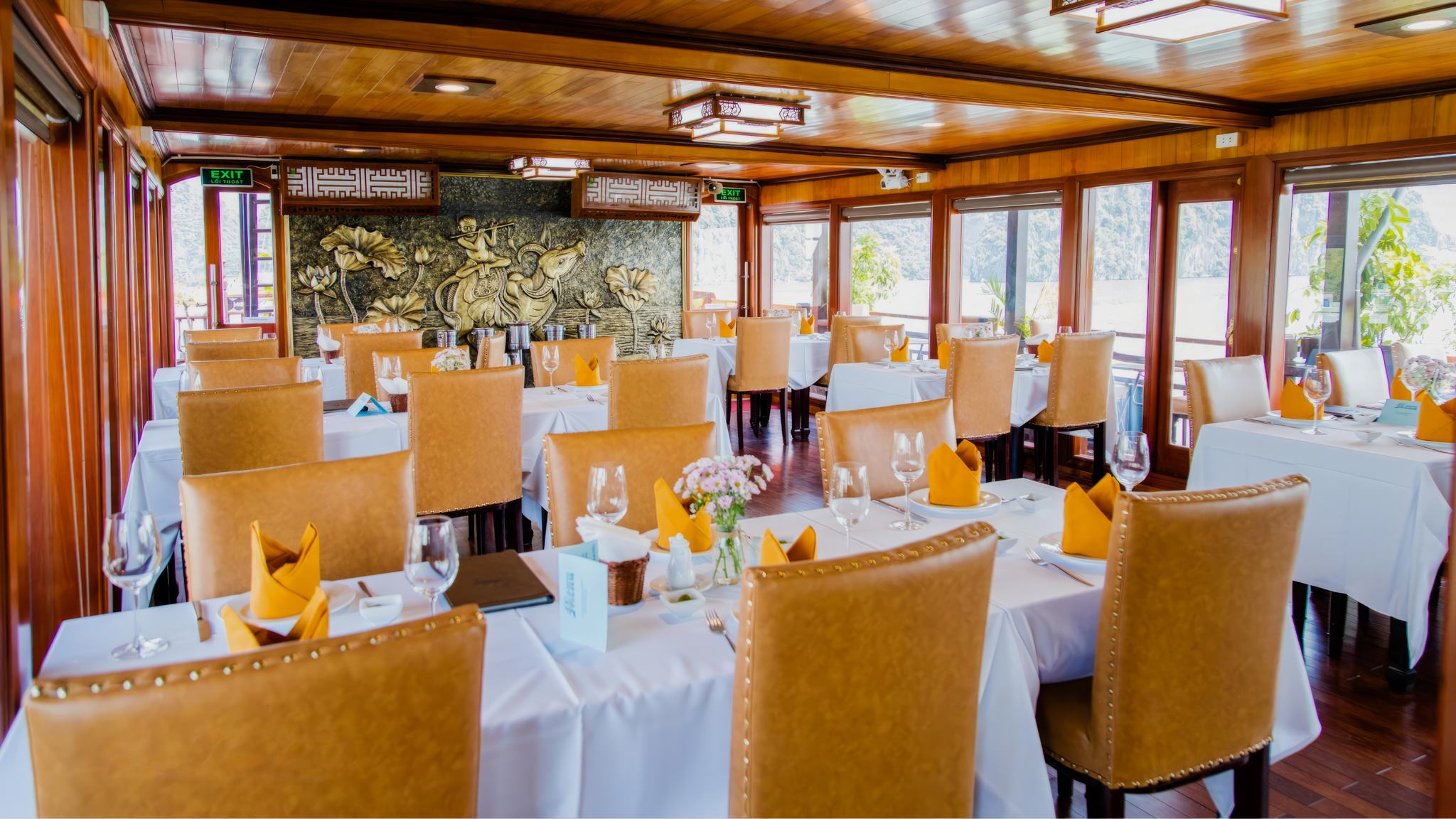 The restaurant on Victory Cruise boat is designed with traditional Vietnamese influences.
