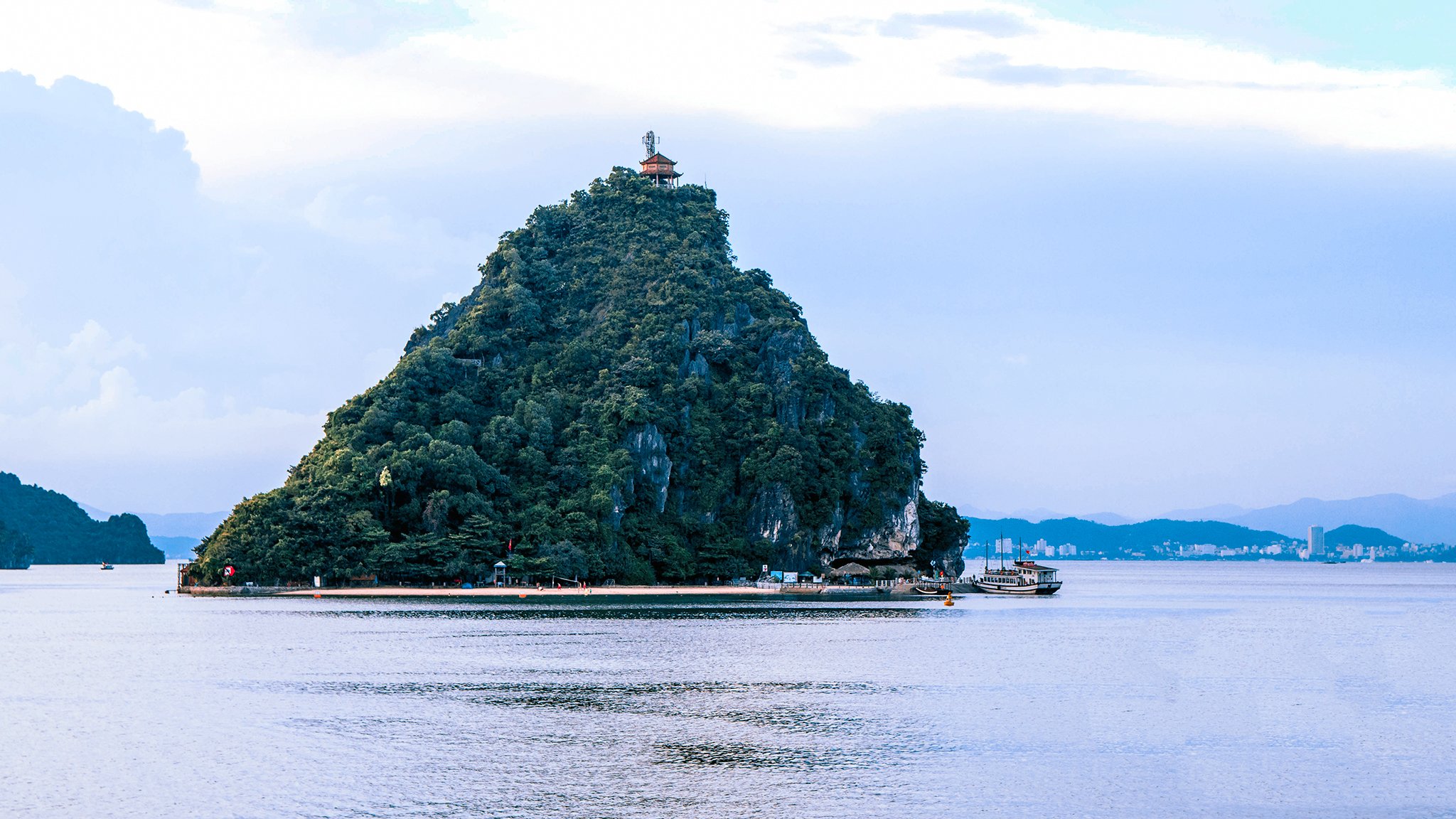 Pretty Titop Island amidst calm Halong Bay