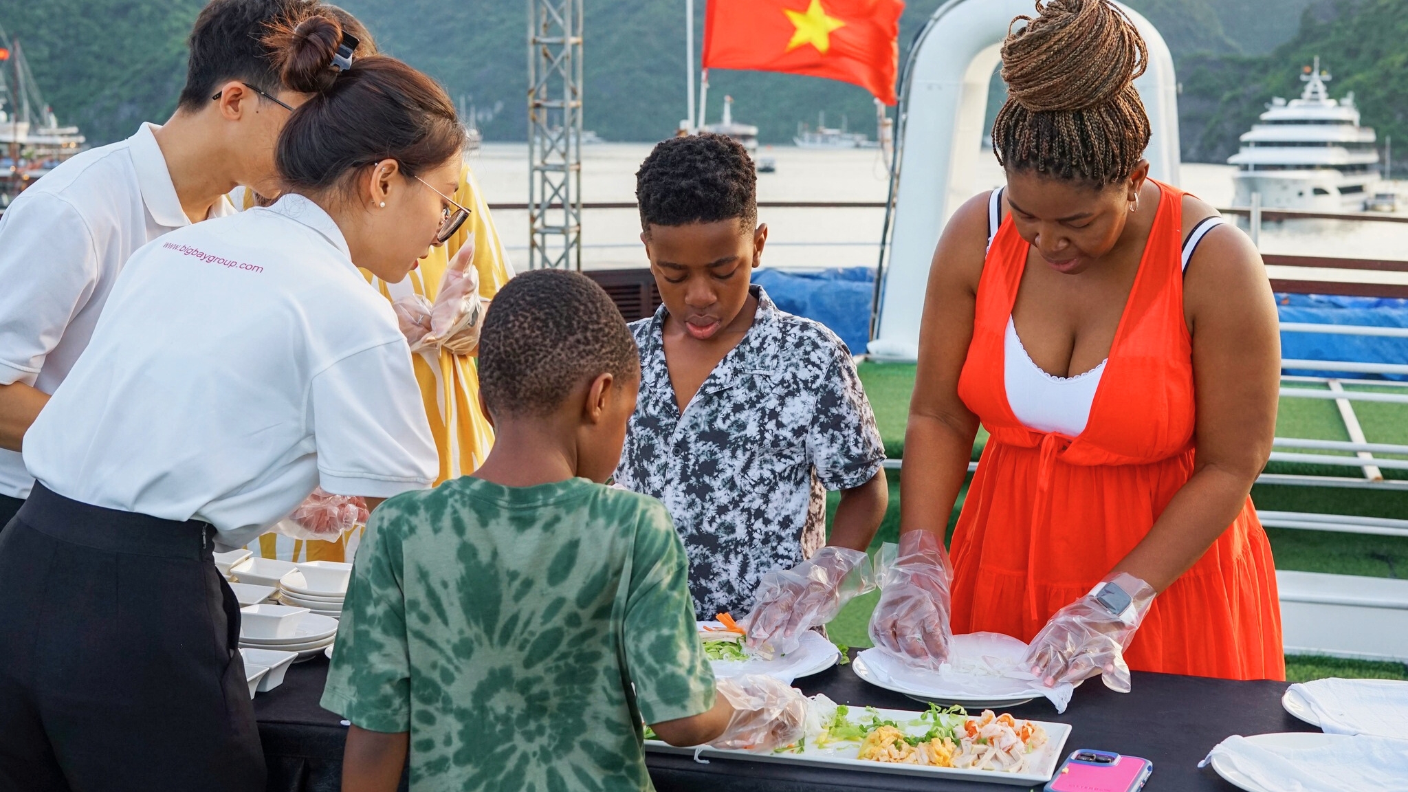 Guests making spring rolls during a Vietnamese cooking class onboard