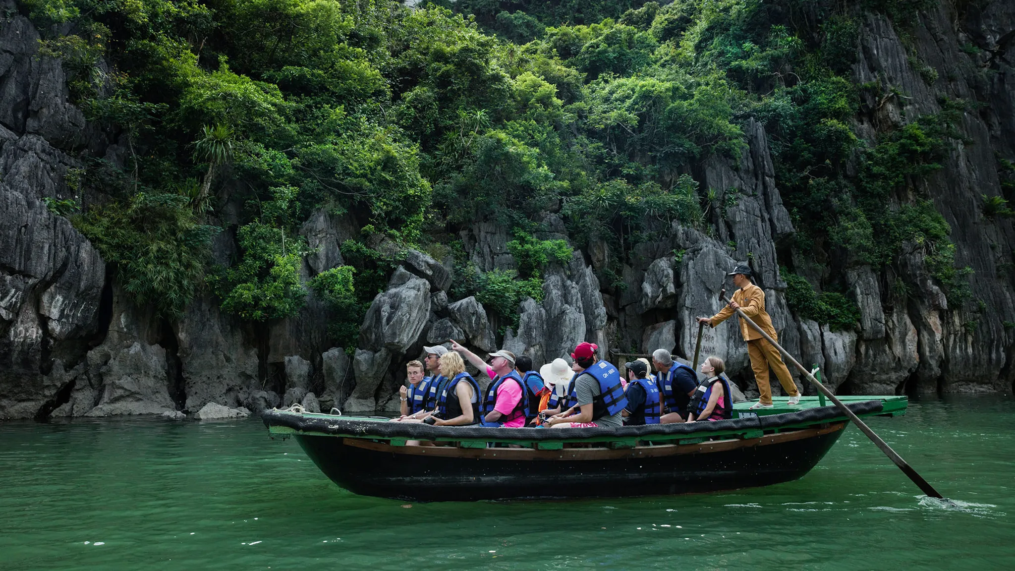 Small boat rowing on Lan Ha Bay