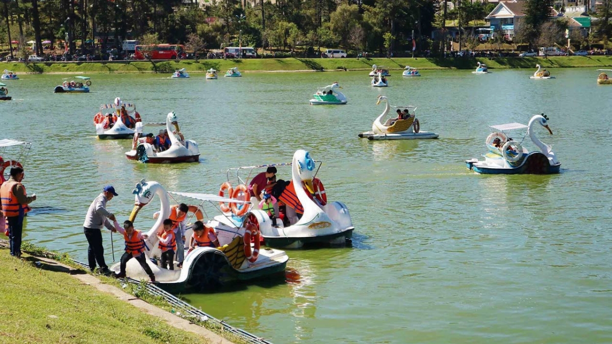 People Enjoy Pedal Boating On The Lake