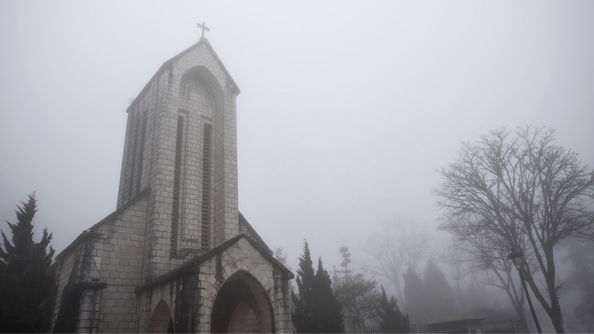 Ancient Stone Church Glowing Softly Under Mountain Fog