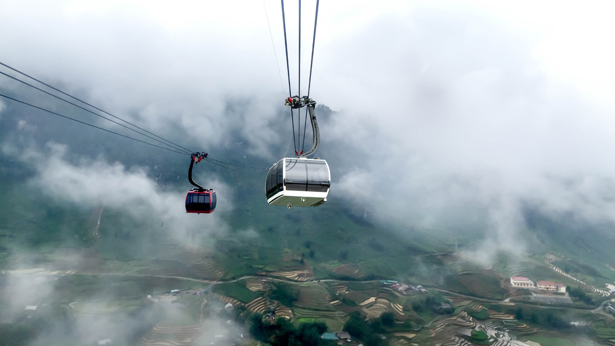 Cabins Departing Toward Fansipan’s Cloud Covered Peak
