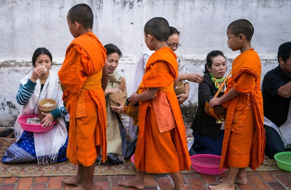 Little Monks Collecting Alms At Tak Bat Ceremony