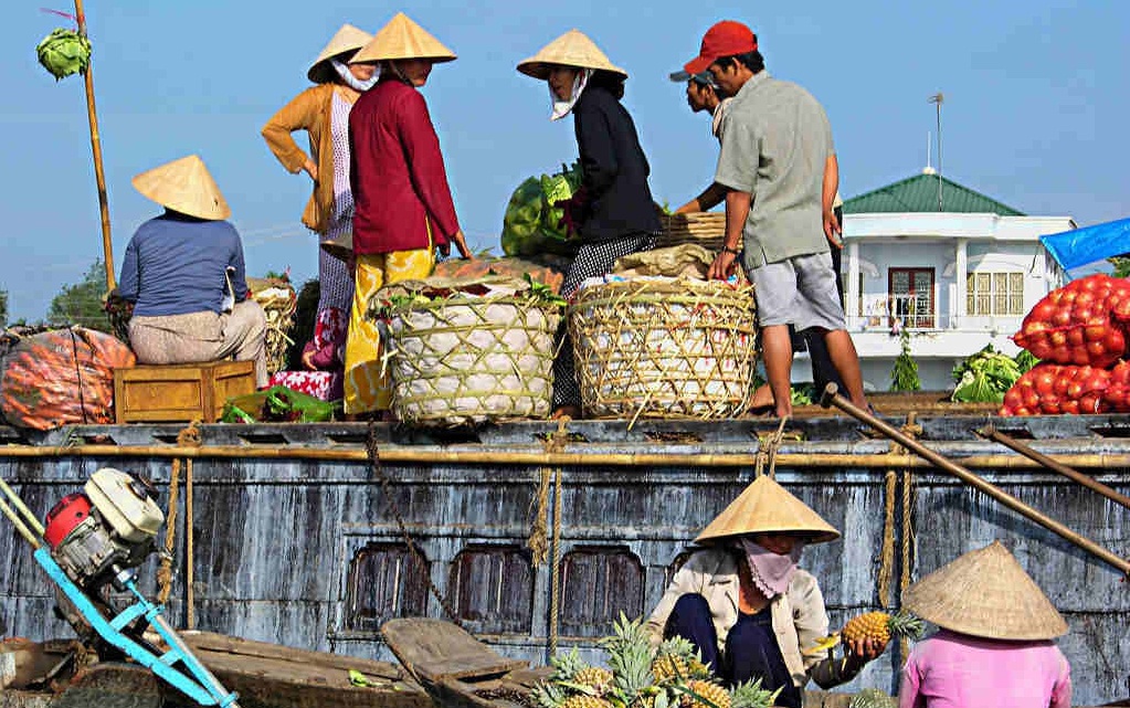 Mingle with locals at the floating markets in Mekong Delta