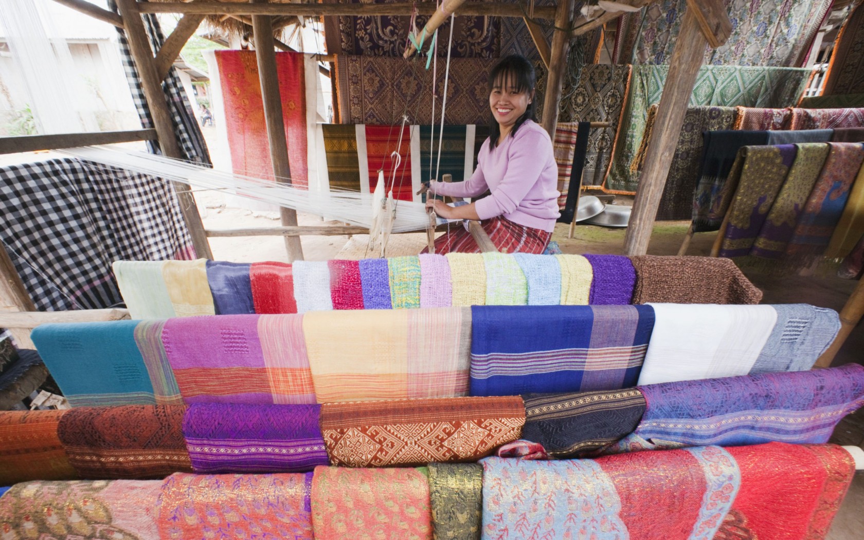 Woman weaving silk scarves