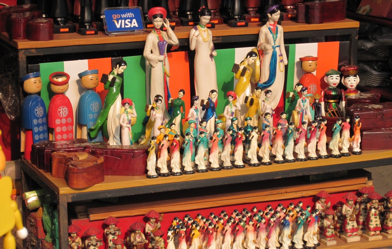 Why not to bring home some of these cute wooden dolls in traditional Vietnamese costumes?