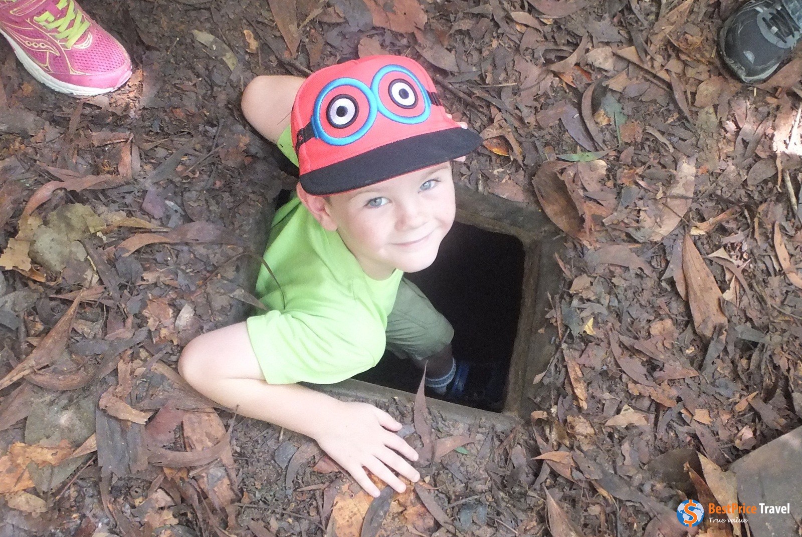 kids explore Cu Chi tunnels