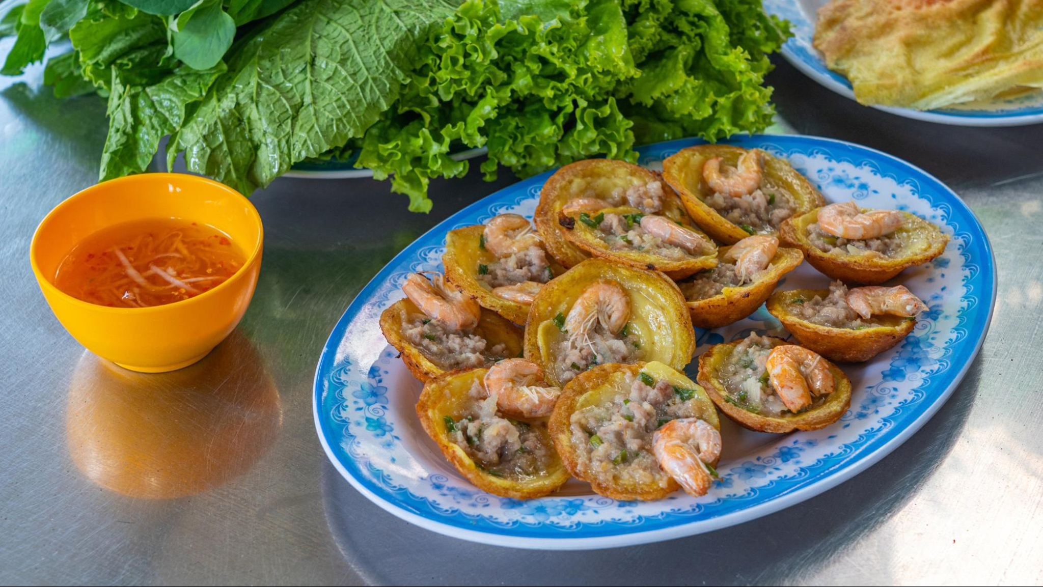 Banh Khot is usually served with sweet sauce and fresh vegetable