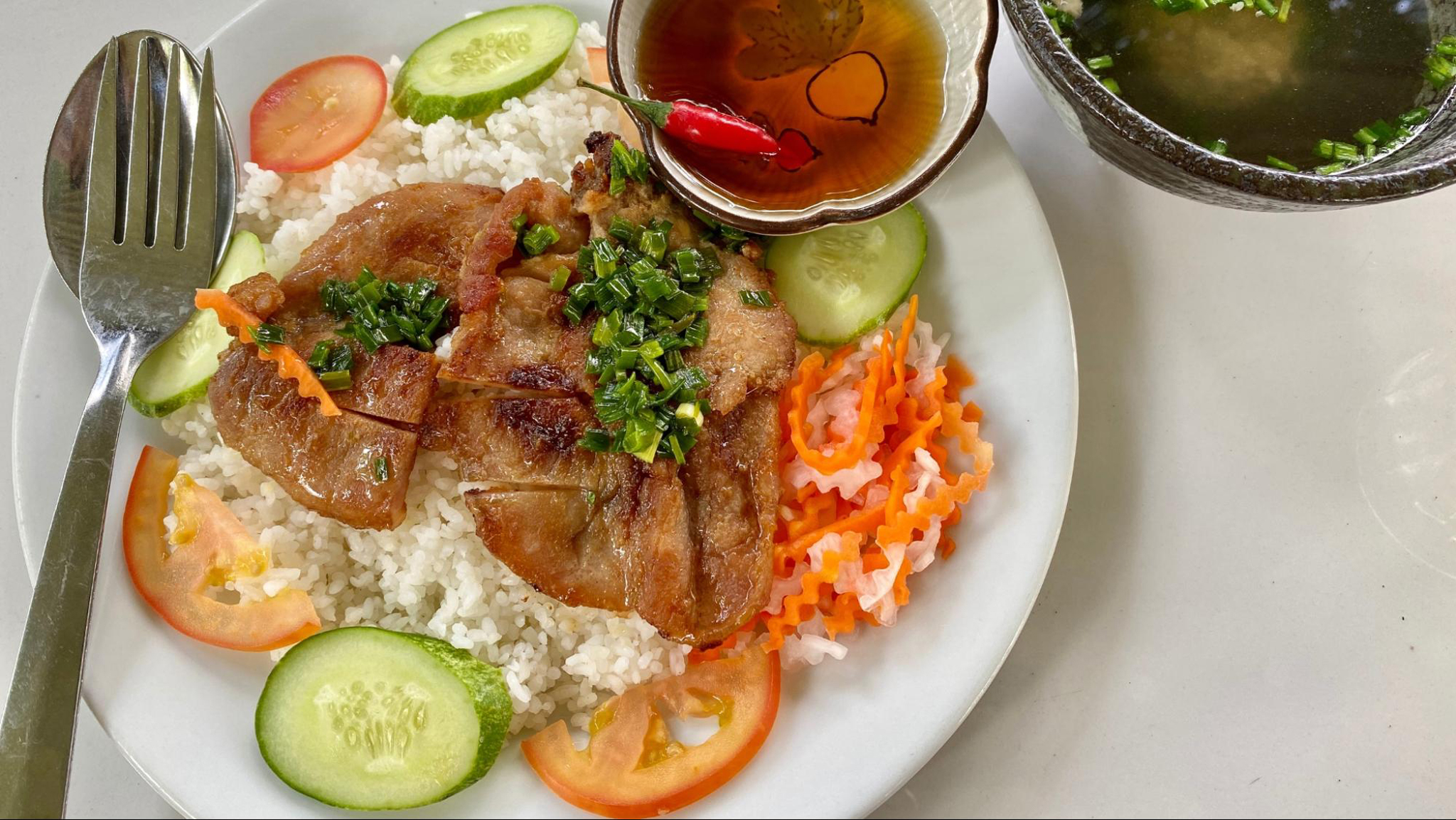 Com Tam is typically served with grilled pork and flavorful toppings