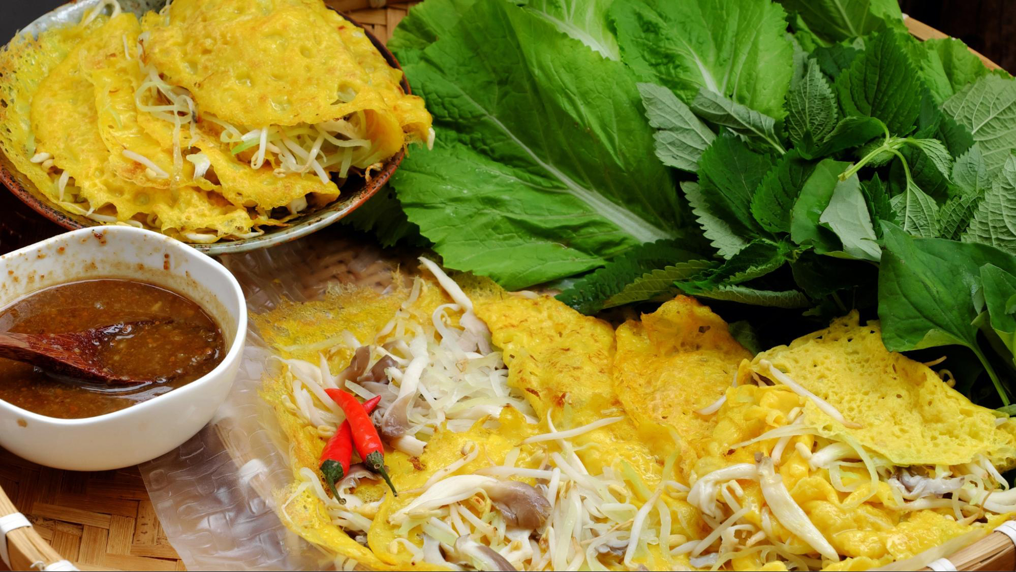 Crispy Banh Xeo filled with shrimp, pork, and bean sprouts