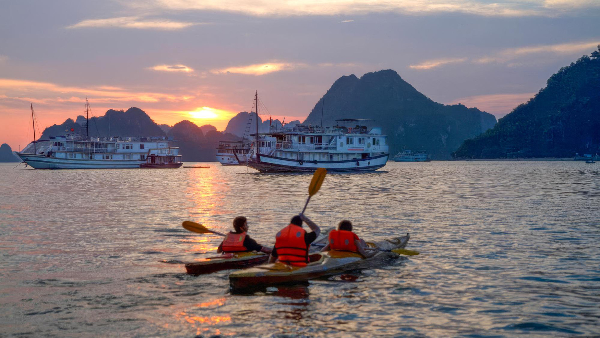 Enjoy the charming sunset view while kayaking on the emerald water