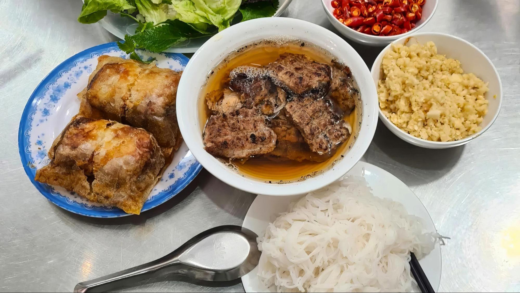 Bun Cha offers a perfect blend of smoky grilled pork and fresh herbs