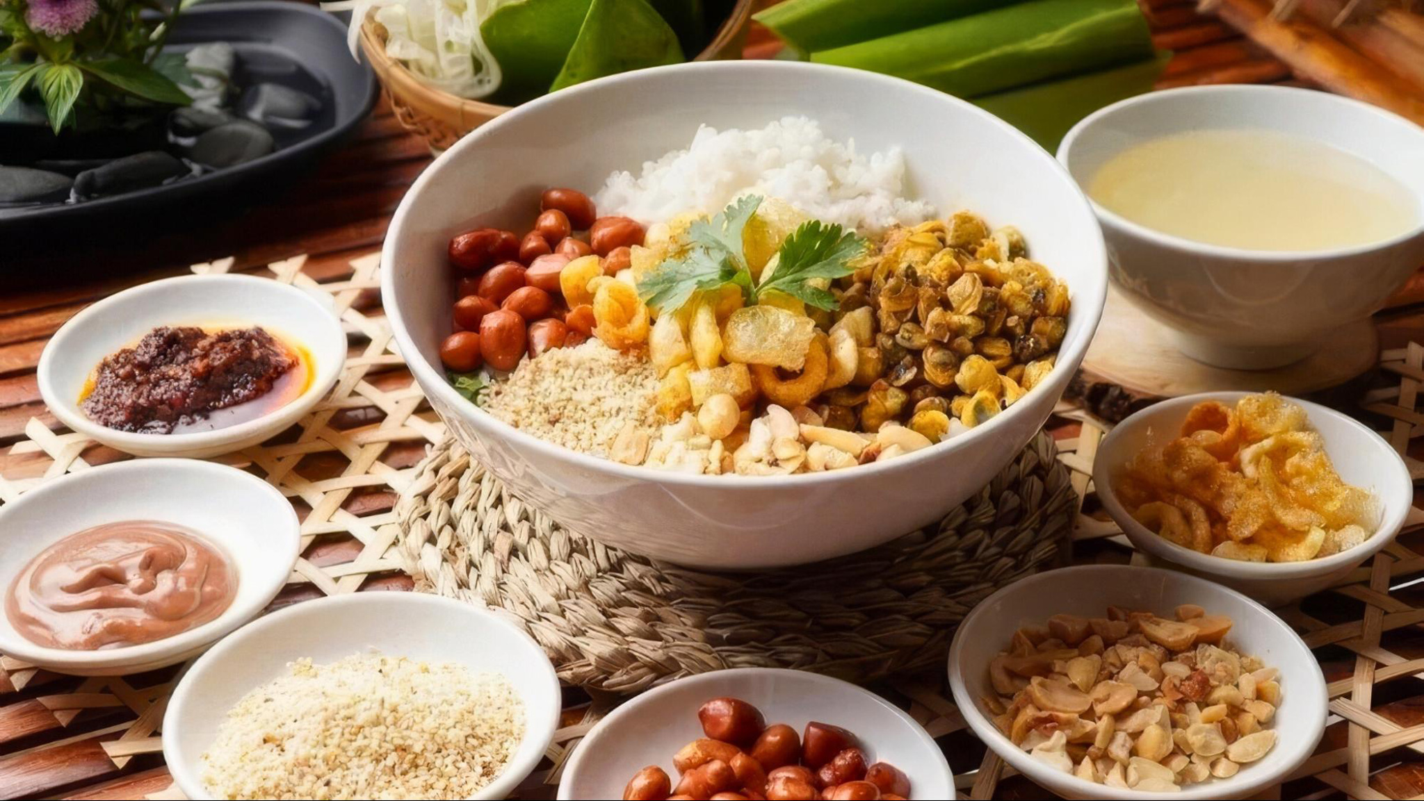 Com Hen brings a delightful mix of tender mussels, crispy pork, and rice