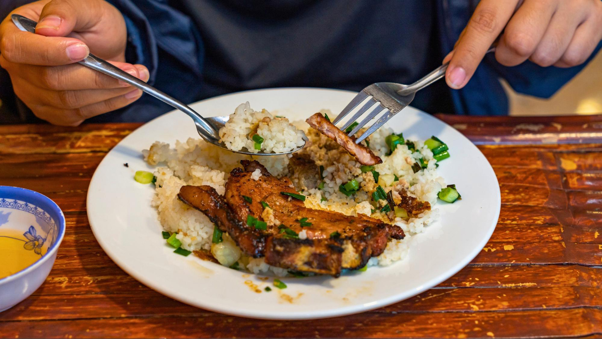 Com Tam delights with tender grilled pork, savory fish sauce, and broken rice