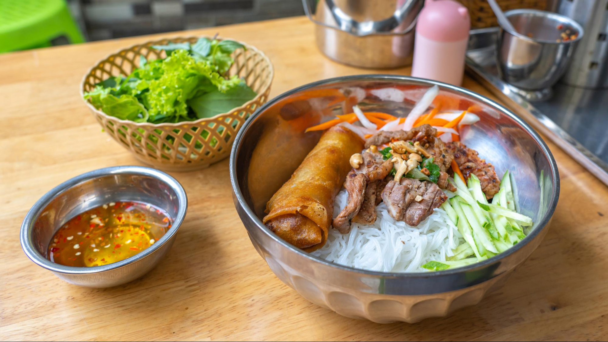 Bun Thit Nuong combines smoky grilled meat, fresh herbs, and soft noodles