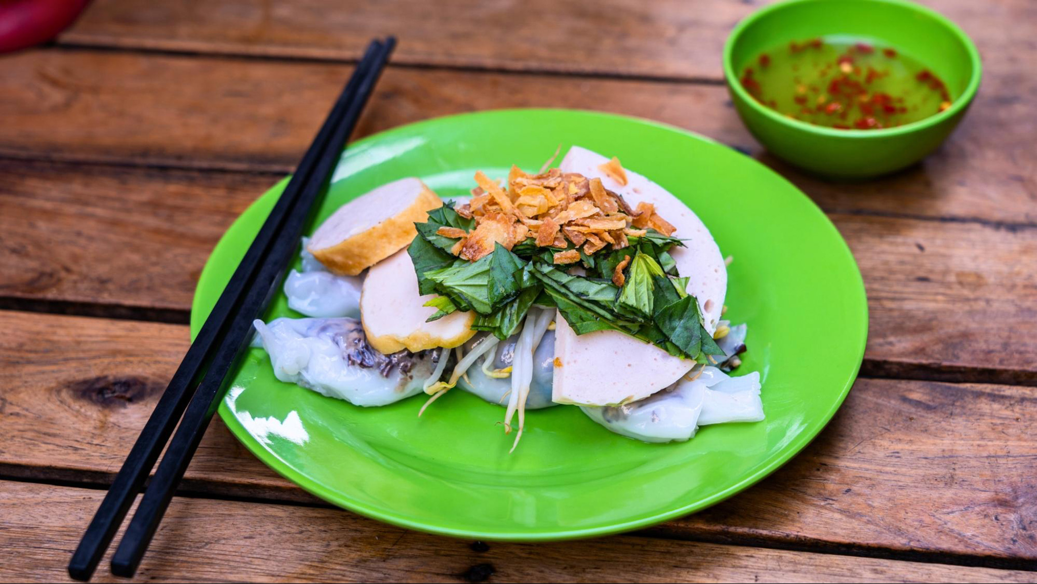 Banh Cuon delights with silky rice rolls, savory fillings, and fresh herbs