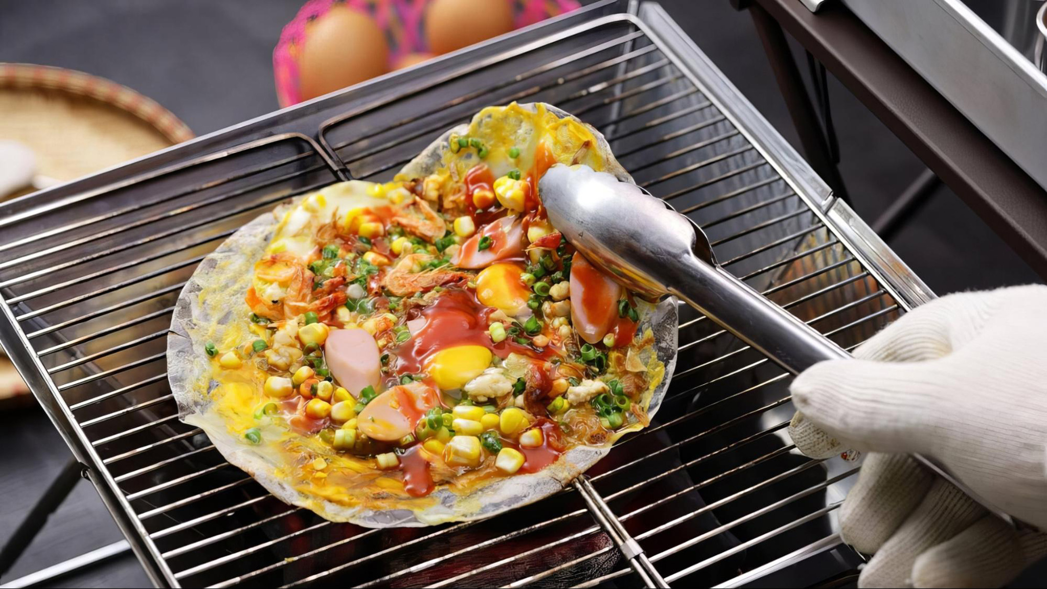 Banh Trang Nuong is crispy and loaded with savory toppings like eggs and sausage