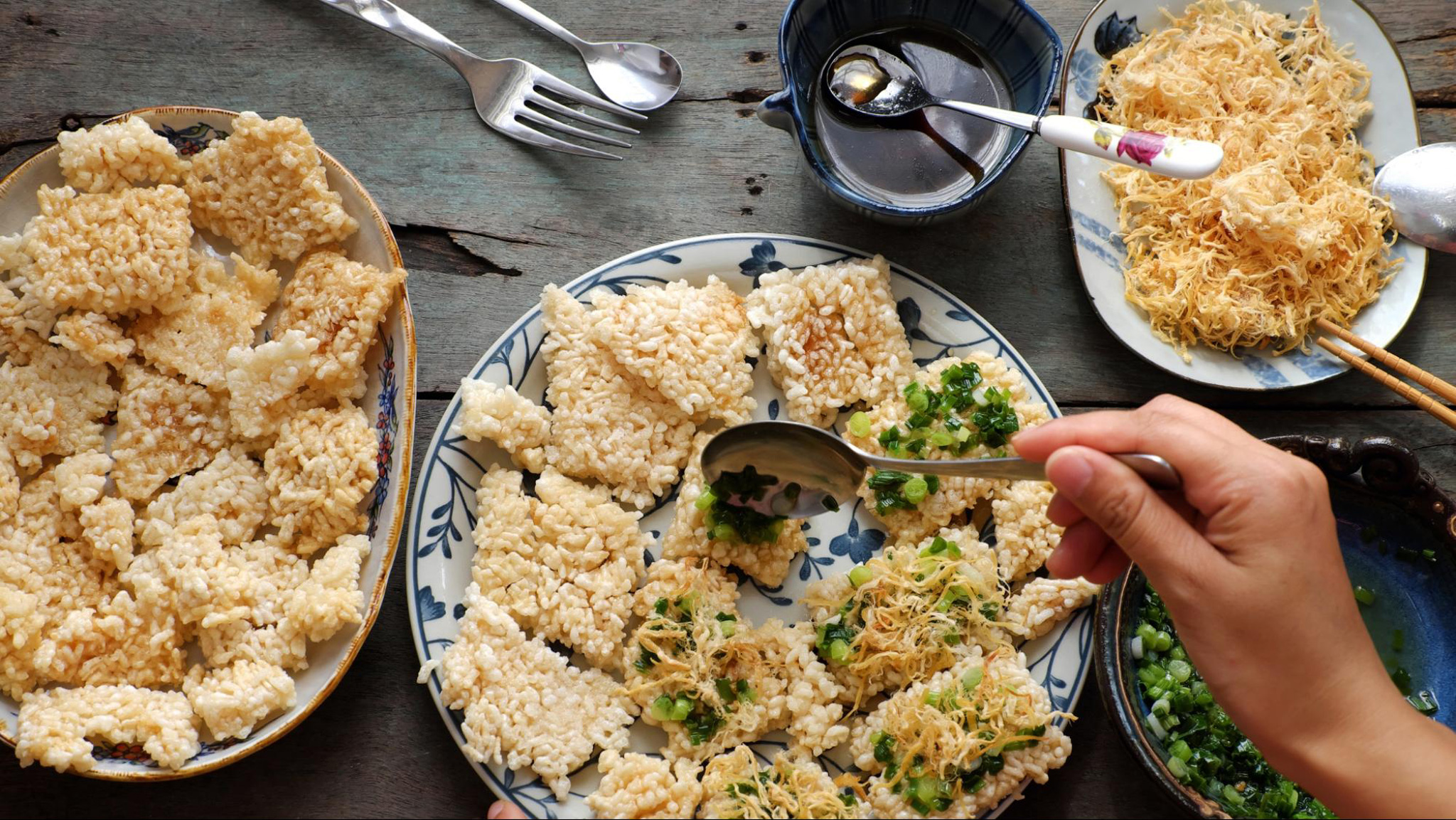 Com Chay is crunchy and savory, topped with flavorful pork floss and chili