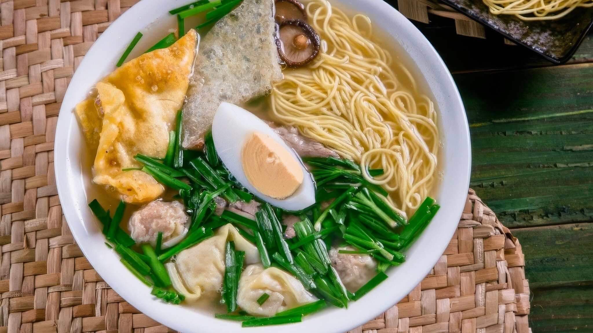 Van Than Noodles Feature A Rich, Flavorful Broth Topped With Tender Meat, Dumplings, Eggs, And Fresh Chives