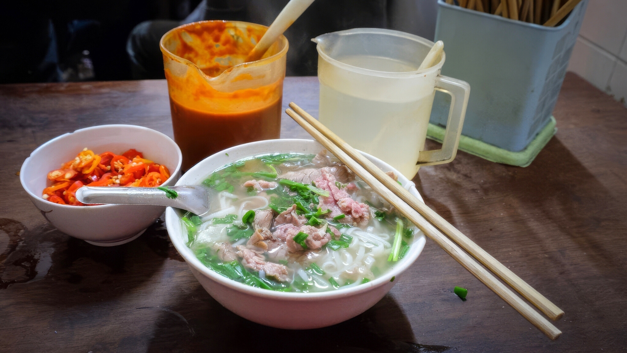 Pho Bat Dan Features A Bowl Of Rice Noodles, A Rich, Aromatic Broth, Tender Slices Of Beef, And A Garnish Of Green Onions