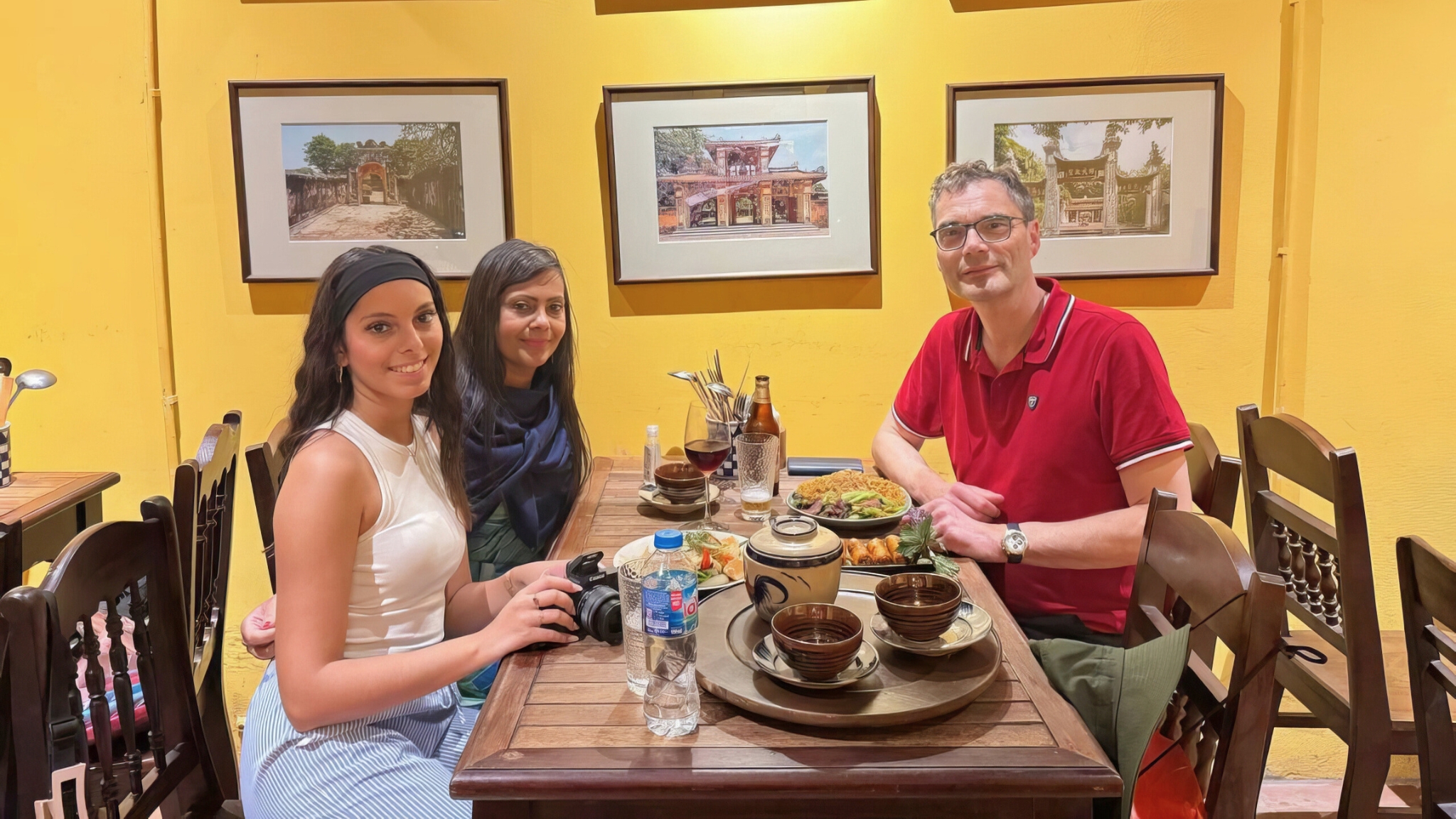 Guests Enjoy Vietnamese Dishes At Simple Wooden Tables, Creating A Warm, Cozy Atmosphere Filled With Laughter And Aromas