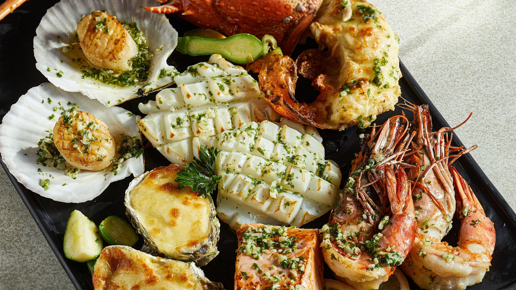 Freshly Grilled Seafood Served With Garlic Butter And Herbs At Hemispheres Steak & Seafood Grill