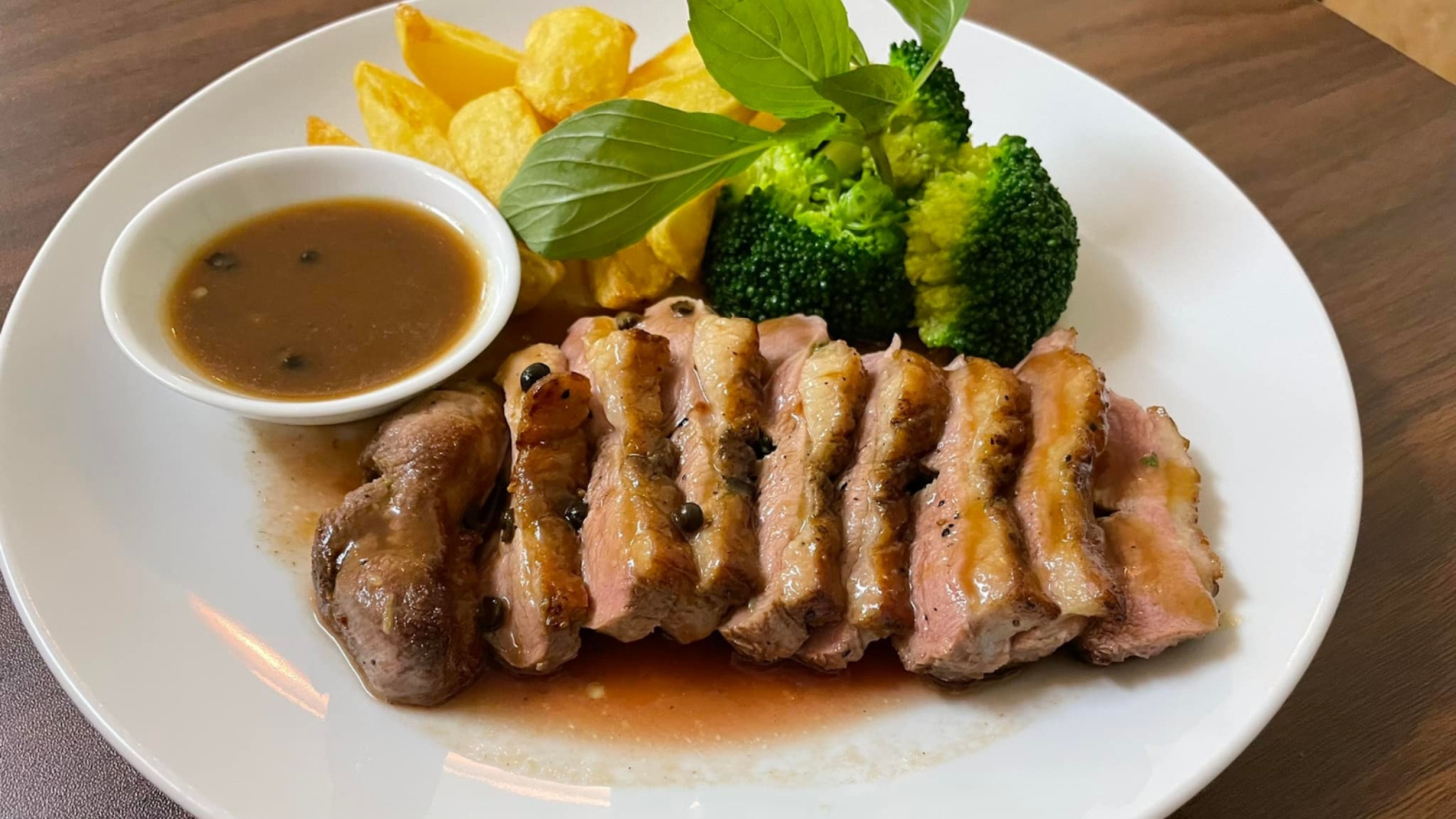Seared Duck Breast Served With Sauce And Fresh Broccoli