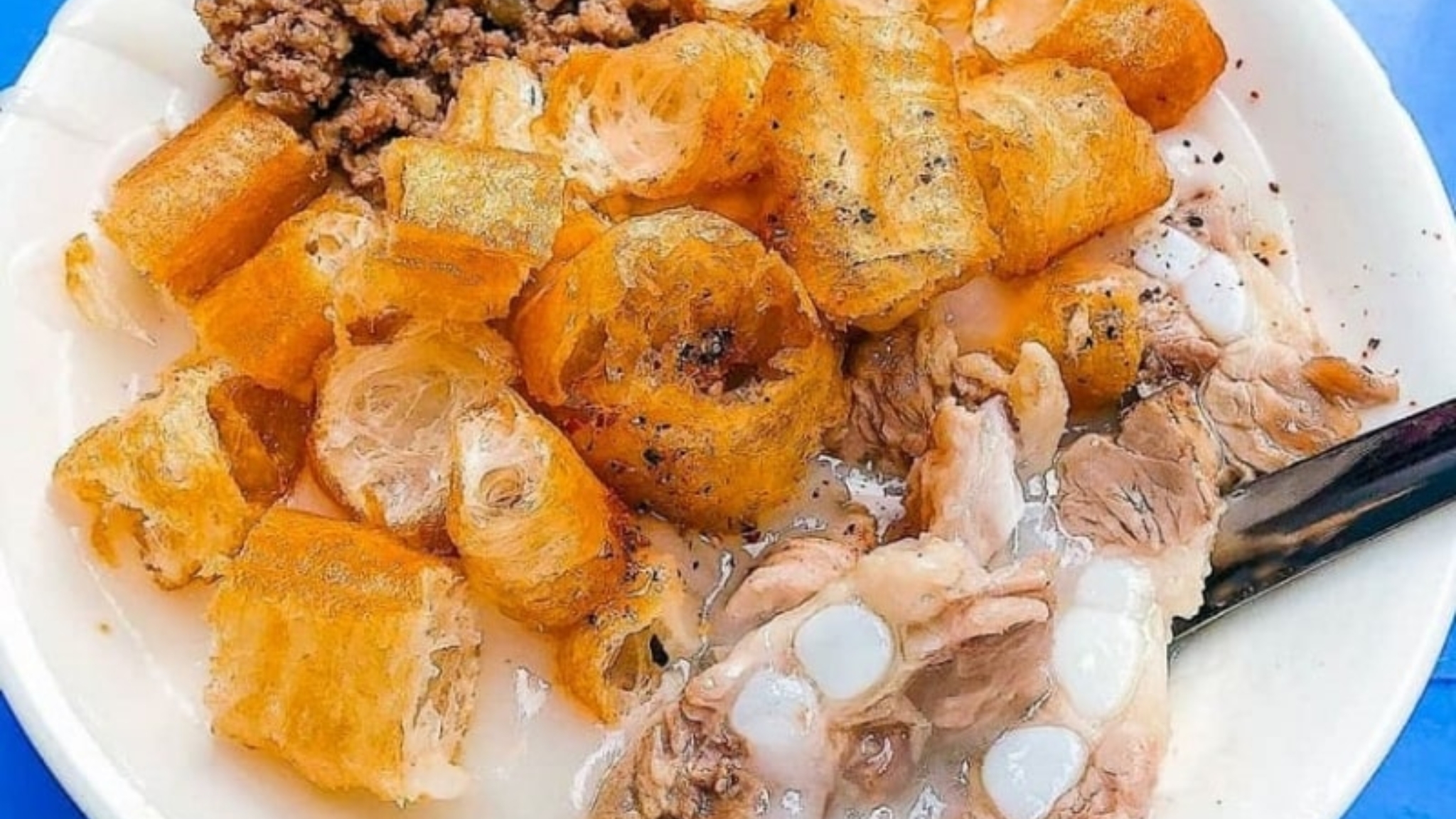 A Hearty Pork Rib Congee Bowl With Fried Dough Sticks, Pork Cartilage And Minced Pork