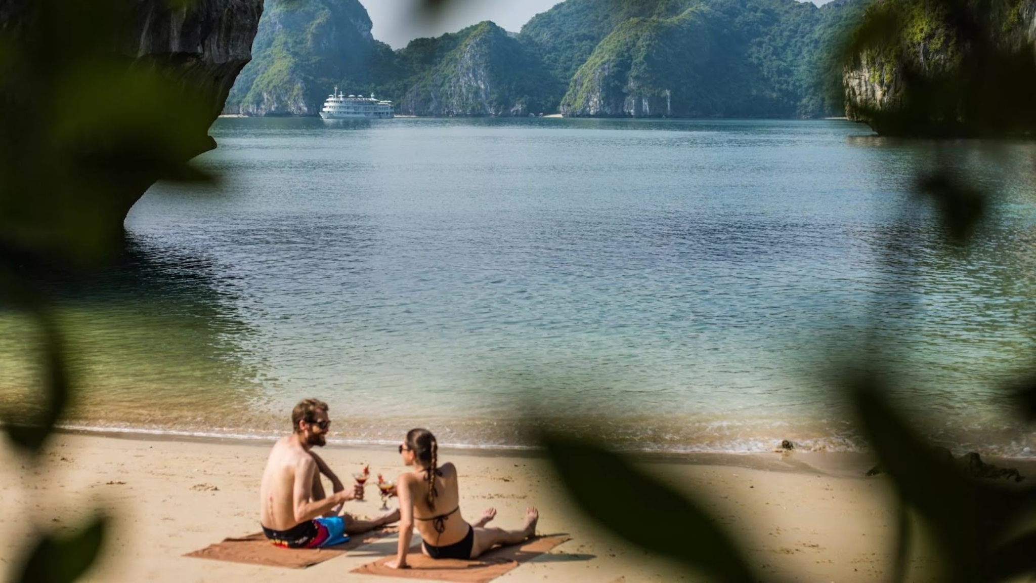 Relaxing On The Golden Sands Of Bai Chay Beach In Halong Bay With Clear Skies And Gentle Waves