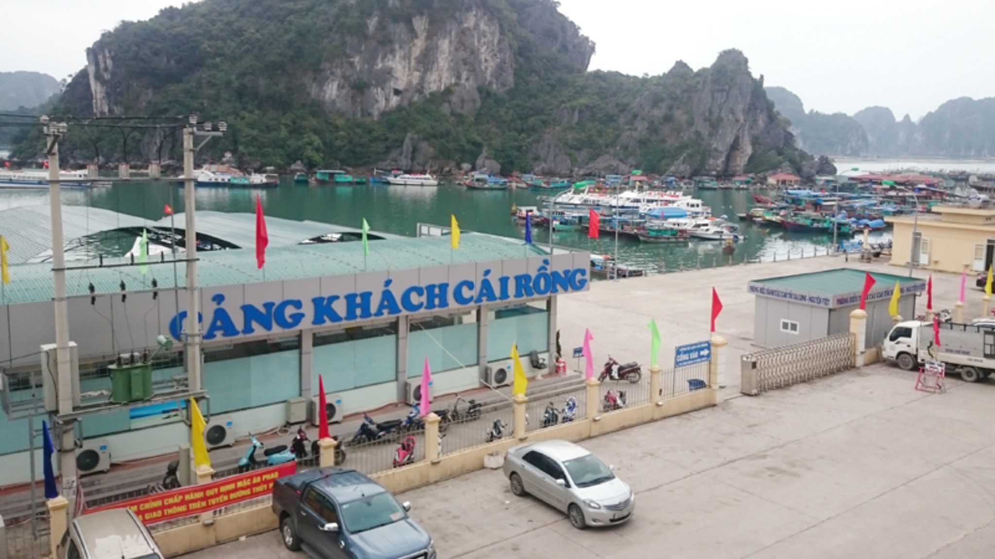 Cai Rong Port with wooden fishing boats and local cargo vessels along the mainland waterfront