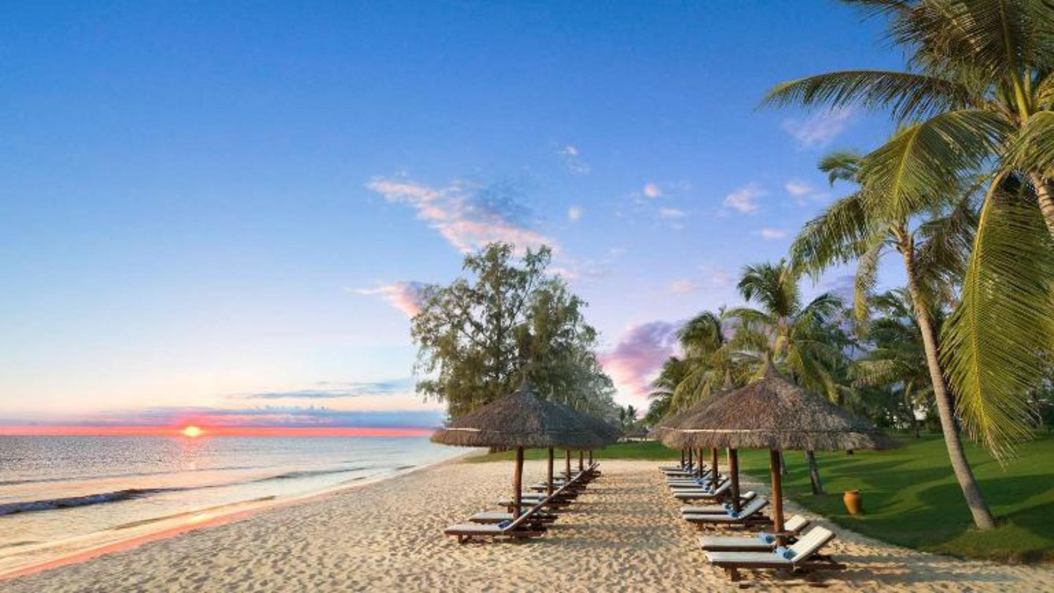 Bai Dai Beach in Van Don with crystal-clear turquoise water, white sand, and rocky islands