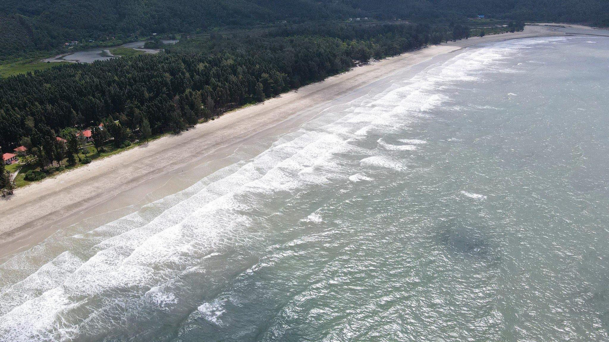 Aerial view of Truong Xuan&nbsp; Beach on Ngoc Vung Island, Van Don, with a curved white-sand shoreline and turquoise sea