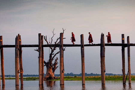 Monks Crossing The U Bein Bridge In Amarapura, The Longest Teak Wood Bridge In The World.