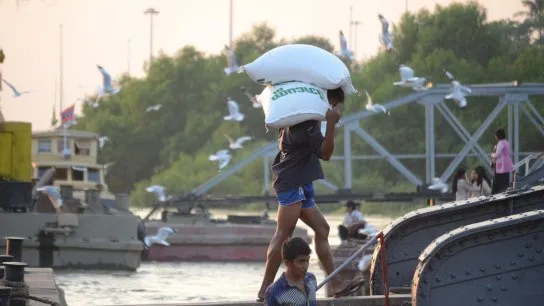 A Labourer Unloading Rice From A Ship At Botahtaung Jetty