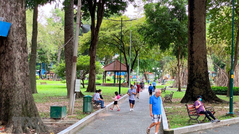 Locals Do Morning Exercises At Tao Dan Park