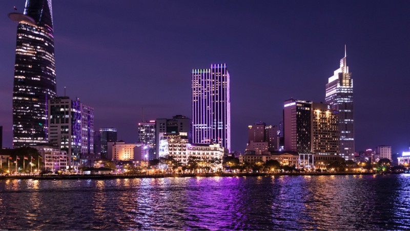 Day 1 Cross Over The Saigon River As The Skyline Glows Gold Against The Evening Sky