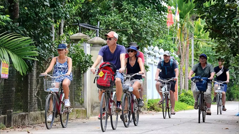 Cycle Through Peaceful Lanes Toward Tra Que, Where Lush Gardens And Friendly Farmers Await
