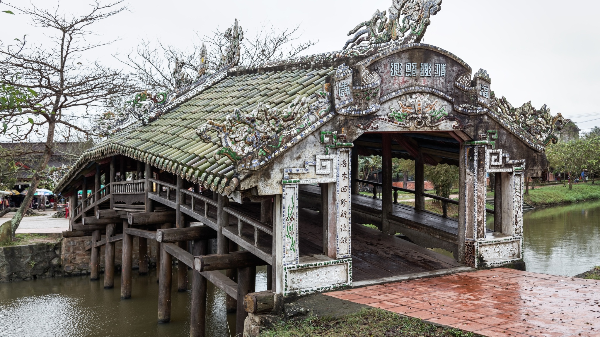Take A Rest At The Ancient Tile Roofed Bridge Surrounded By Peaceful Scenery