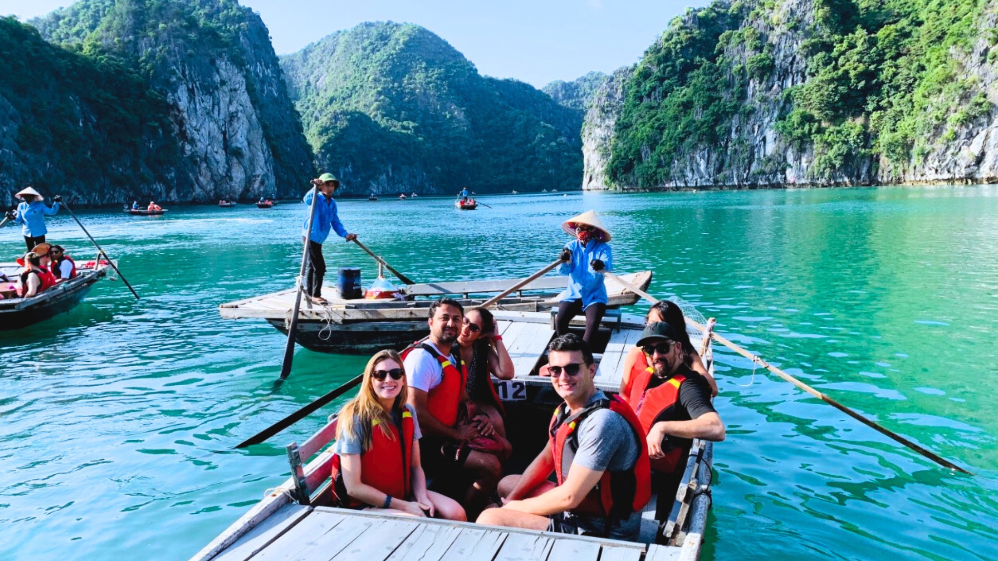 Take a traditional rowing boat for the stunning water cave exploration